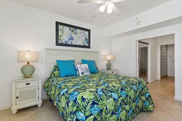 bedroom featuring light tile patterned floors, baseboards, and a ceiling fan