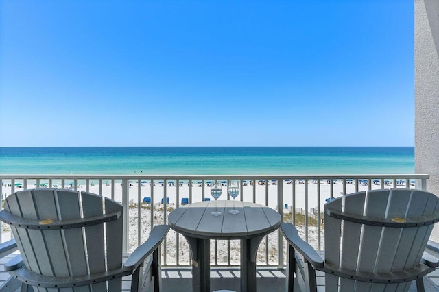 balcony with view of water and beach