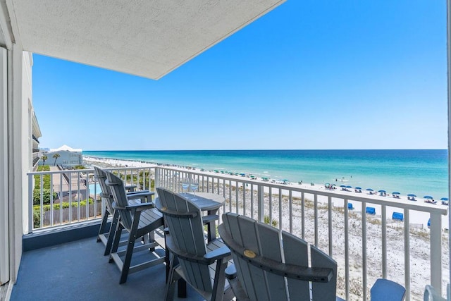 balcony featuring view of water and beach