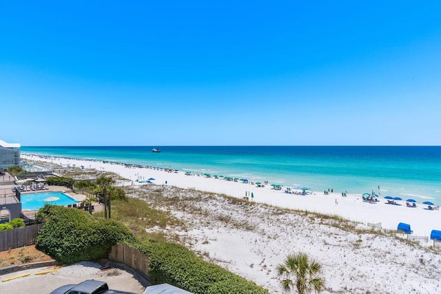 water view with nearby beach and fence