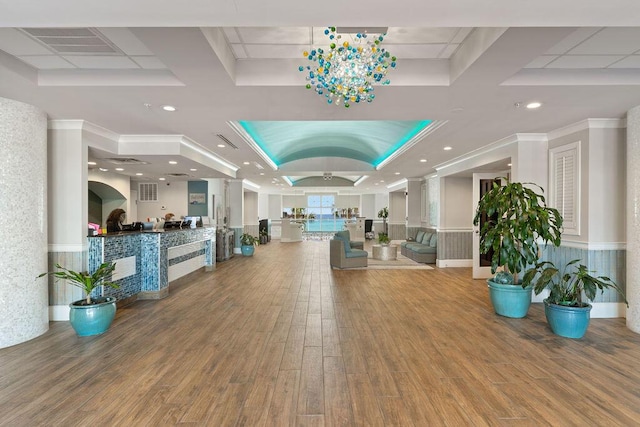 reception area featuring coffered ceiling and ornamental molding