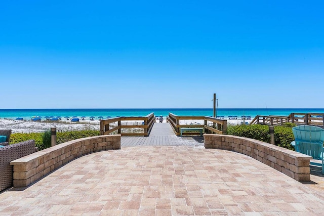 view of patio featuring view of water and beach