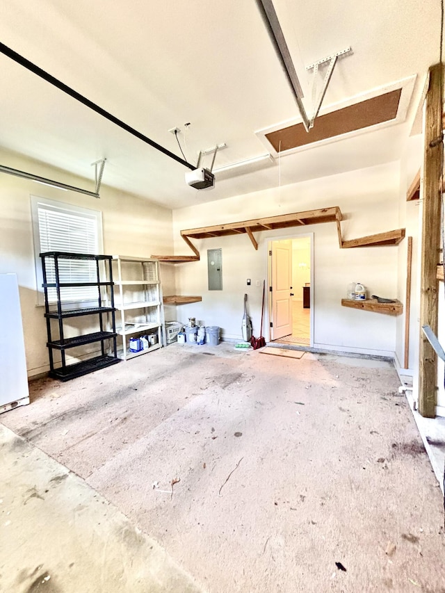134 Rivercrest Cir, Santa Rosa Beach, FL 32459 - garage with electric panel, a garage door opener, and freestanding refrigerator