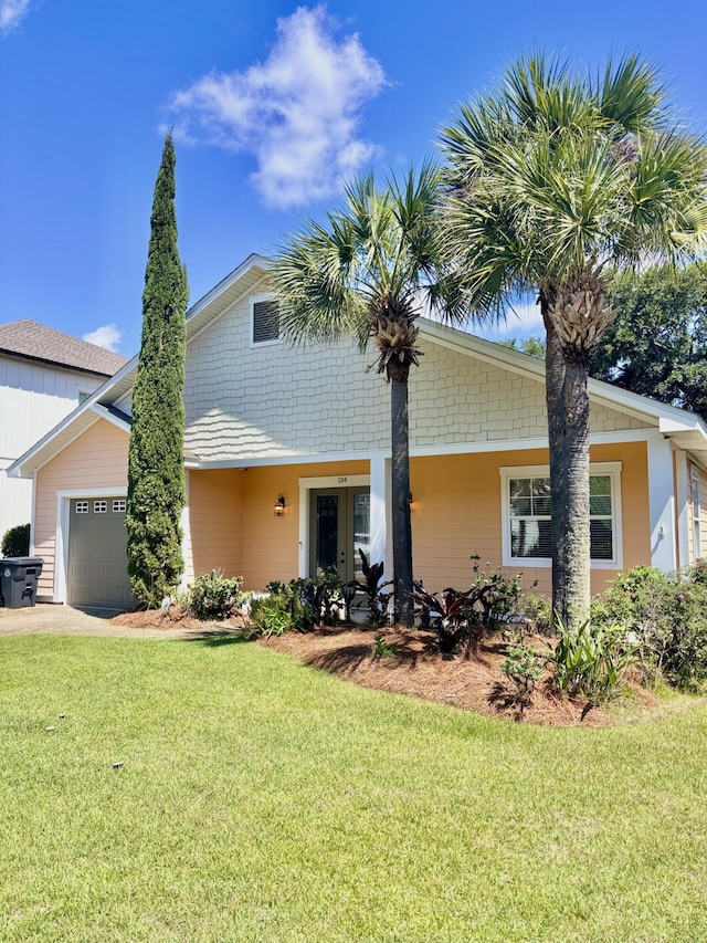 134 Rivercrest Cir, Santa Rosa Beach, FL 32459 - view of front facade with a front lawn, a garage, french doors, and driveway