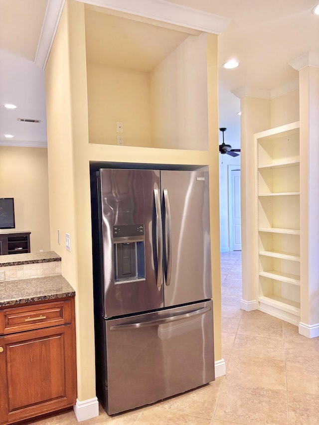 134 Rivercrest Cir, Santa Rosa Beach, FL 32459 - kitchen with stainless steel fridge, stone countertops, brown cabinets, recessed lighting, and light tile patterned floors