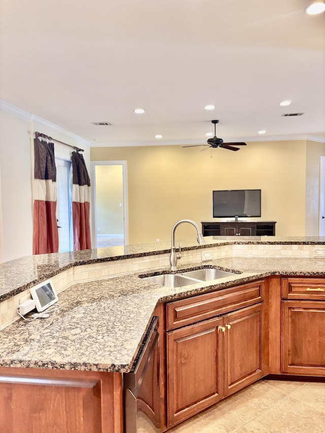 134 Rivercrest Cir, Santa Rosa Beach, FL 32459 - kitchen featuring a sink, dishwasher, brown cabinetry, light stone counters, and crown molding