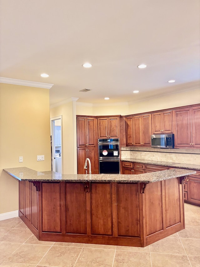 134 Rivercrest Cir, Santa Rosa Beach, FL 32459 - kitchen featuring stainless steel appliances, stone countertops, decorative backsplash, a kitchen bar, and crown molding