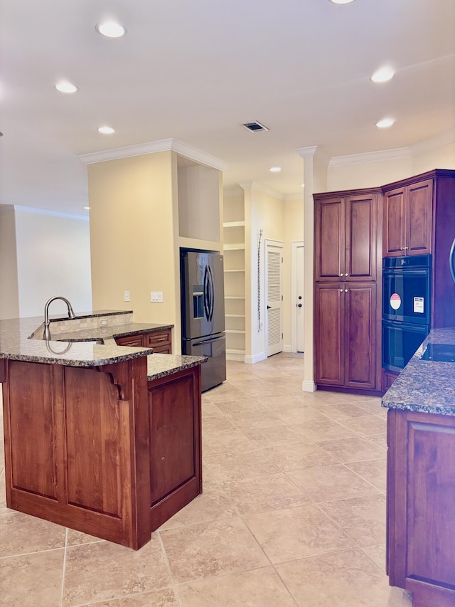 134 Rivercrest Cir, Santa Rosa Beach, FL 32459 - kitchen with stainless steel refrigerator with ice dispenser, ornamental molding, dark stone counters, recessed lighting, and a kitchen breakfast bar