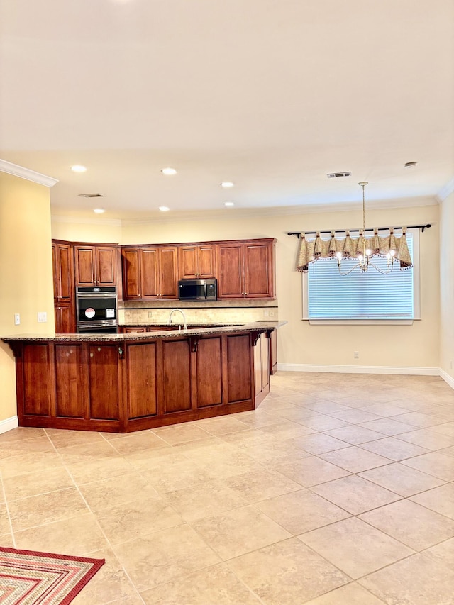 134 Rivercrest Cir, Santa Rosa Beach, FL 32459 - kitchen featuring stainless steel microwave, crown molding, a chandelier, dark stone countertops, and decorative backsplash