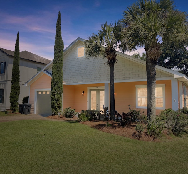 134 Rivercrest Cir, Santa Rosa Beach, FL 32459 - view of front facade with a front lawn, an attached garage, french doors, and driveway