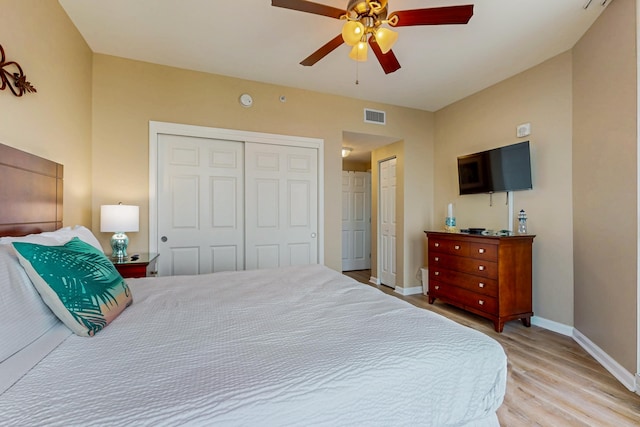 bedroom with visible vents, a ceiling fan, light wood-style floors, and baseboards