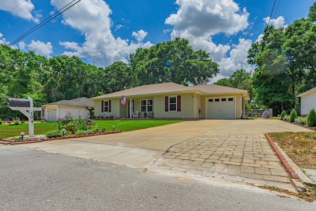 single story home featuring a garage, driveway, and a front lawn