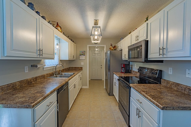 kitchen with light tile patterned flooring, dark countertops, white cabinets, a sink, and black appliances