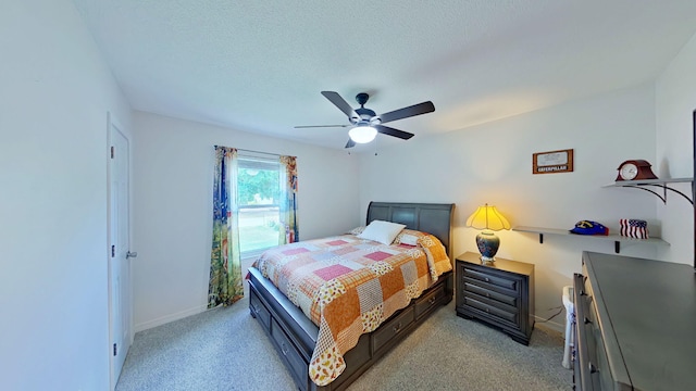 bedroom with a ceiling fan, baseboards, and light carpet