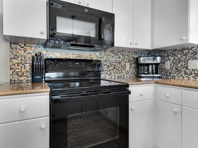 kitchen featuring light stone counters, white cabinets, backsplash, and black appliances