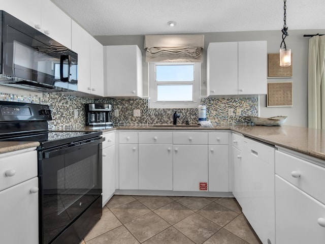 kitchen with backsplash, white cabinetry, a sink, and black appliances
