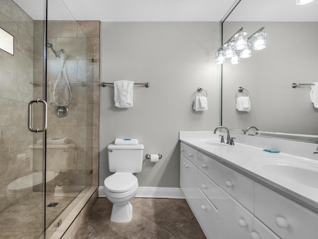 full bathroom with toilet, baseboards, tiled shower, and a sink