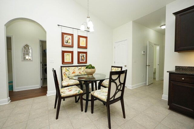 614 Red Fern Rd, Crestview, FL 32536 - dining room featuring arched walkways, light tile patterned flooring, a chandelier, baseboards, and lofted ceiling