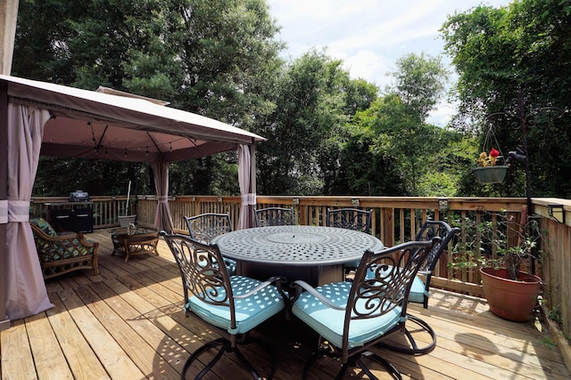 614 Red Fern Rd, Crestview, FL 32536 - wooden terrace featuring a gazebo, outdoor dining space, and view of wooded area