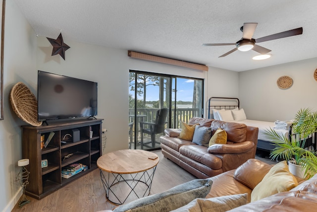300 Cain Rd Unit 320, Panama City Beach, FL 32413 - living room with a textured ceiling, ceiling fan, and wood finished floors
