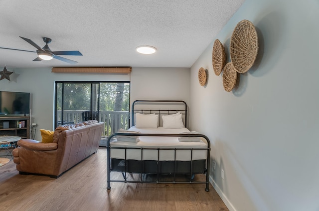 300 Cain Rd Unit 320, Panama City Beach, FL 32413 - bedroom with a textured ceiling, wood finished floors, and access to exterior