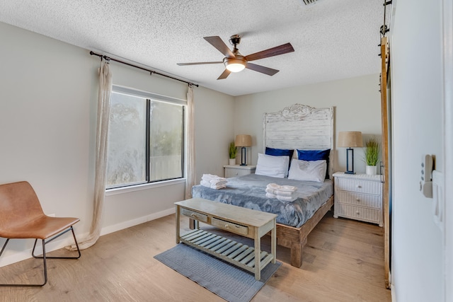300 Cain Rd Unit 320, Panama City Beach, FL 32413 - bedroom featuring light wood-style floors, a textured ceiling, and baseboards