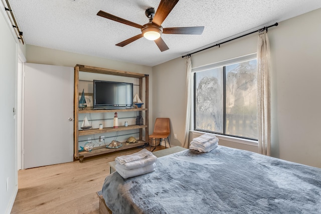 300 Cain Rd Unit 320, Panama City Beach, FL 32413 - bedroom featuring a ceiling fan, a textured ceiling, and wood finished floors