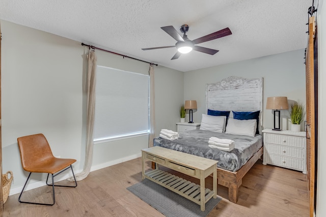 300 Cain Rd Unit 320, Panama City Beach, FL 32413 - bedroom featuring baseboards, a textured ceiling, ceiling fan, and wood finished floors