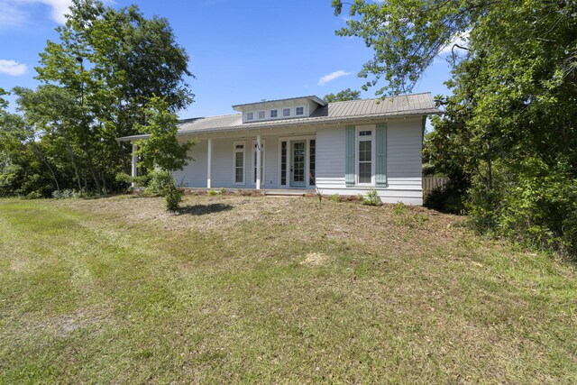 1429 N County Highway 393, Santa Rosa Beach, FL 32459 - view of front facade featuring covered porch, metal roof, and a front lawn