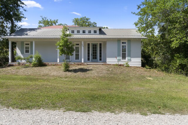 1429 N County Highway 393, Santa Rosa Beach, FL 32459 - rear view of house with a yard, covered porch, and metal roof