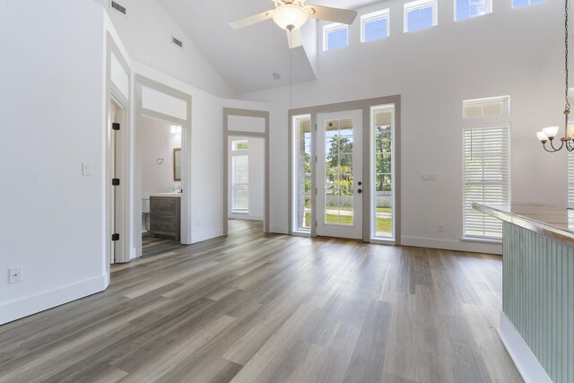 1429 N County Highway 393, Santa Rosa Beach, FL 32459 - unfurnished living room featuring high vaulted ceiling, plenty of natural light, and ceiling fan with notable chandelier