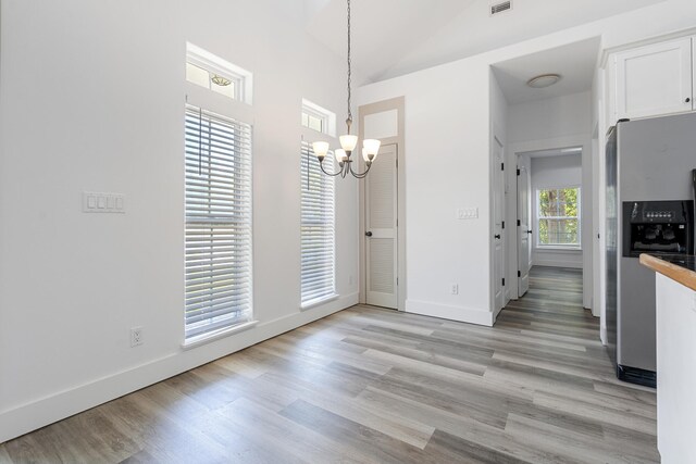 1429 N County Highway 393, Santa Rosa Beach, FL 32459 - unfurnished dining area with light wood-style floors, baseboards, and a chandelier