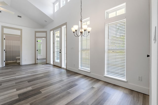 1429 N County Highway 393, Santa Rosa Beach, FL 32459 - foyer entrance with visible vents, wood finished floors, high vaulted ceiling, baseboards, and an inviting chandelier