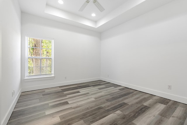 1429 N County Highway 393, Santa Rosa Beach, FL 32459 - empty room with ceiling fan, recessed lighting, baseboards, wood finished floors, and a tray ceiling