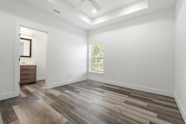 1429 N County Highway 393, Santa Rosa Beach, FL 32459 - unfurnished bedroom featuring visible vents, wood finished floors, a raised ceiling, baseboards, and recessed lighting