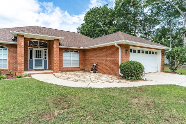 6100 Buck Ward Rd, Baker, FL 32531 - ranch-style home with a garage, a front lawn, roof with shingles, brick siding, and concrete driveway