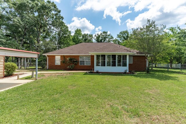 6100 Buck Ward Rd, Baker, FL 32531 - single story home featuring a sunroom, brick siding, fence, and a front yard