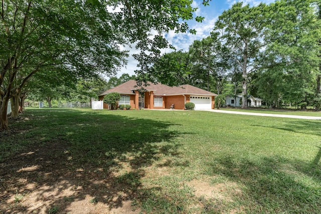 6100 Buck Ward Rd, Baker, FL 32531 - ranch-style house featuring an attached garage, a front lawn, and driveway
