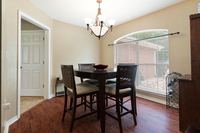 6100 Buck Ward Rd, Baker, FL 32531 - dining area featuring dark wood-style flooring, baseboards, an inviting chandelier, and plenty of natural light
