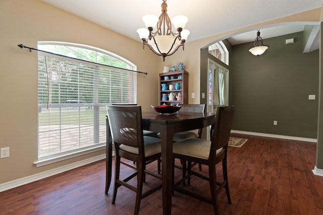6100 Buck Ward Rd, Baker, FL 32531 - dining area featuring arched walkways, baseboards, a notable chandelier, and wood finished floors