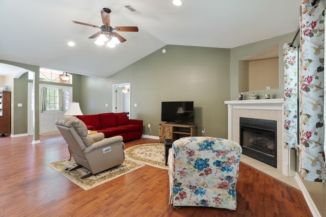 6100 Buck Ward Rd, Baker, FL 32531 - living area featuring ceiling fan, a fireplace, arched walkways, vaulted ceiling, and visible vents