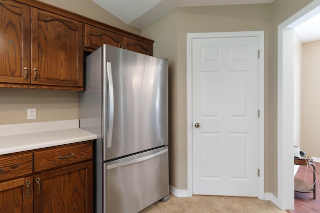 6100 Buck Ward Rd, Baker, FL 32531 - kitchen featuring baseboards, freestanding refrigerator, light tile patterned floors, and light countertops