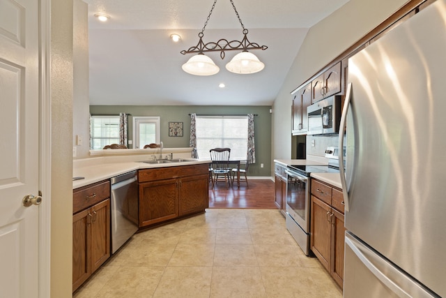 6100 Buck Ward Rd, Baker, FL 32531 - kitchen with a sink, light countertops, stainless steel appliances, light tile patterned floors, and vaulted ceiling