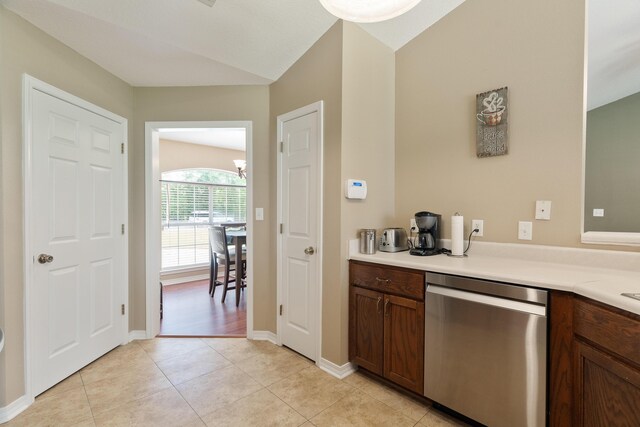 6100 Buck Ward Rd, Baker, FL 32531 - kitchen featuring stainless steel dishwasher, light countertops, baseboards, and light tile patterned floors
