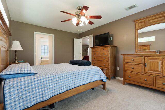 6100 Buck Ward Rd, Baker, FL 32531 - bedroom with connected bathroom, light colored carpet, a ceiling fan, baseboards, and visible vents