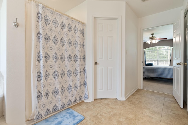 6100 Buck Ward Rd, Baker, FL 32531 - ensuite bathroom featuring a ceiling fan, tile patterned floors, a shower with shower curtain, and ensuite bath