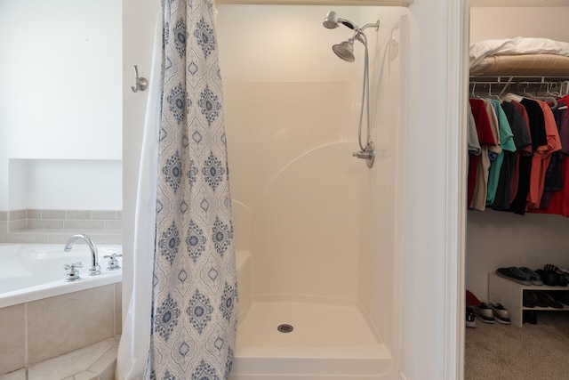 6100 Buck Ward Rd, Baker, FL 32531 - full bath featuring a walk in closet, a shower stall, and a bath