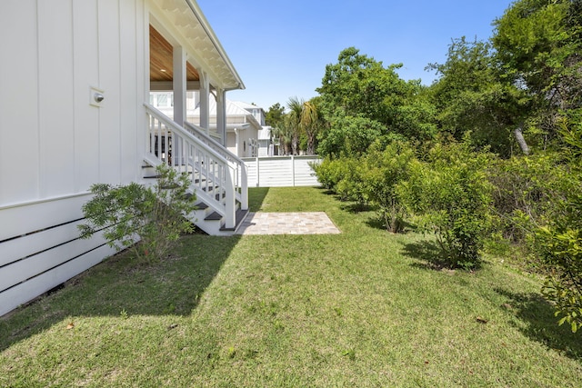 view of yard with stairs, a patio, and fence