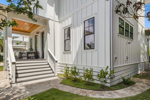 view of property exterior with a porch and board and batten siding