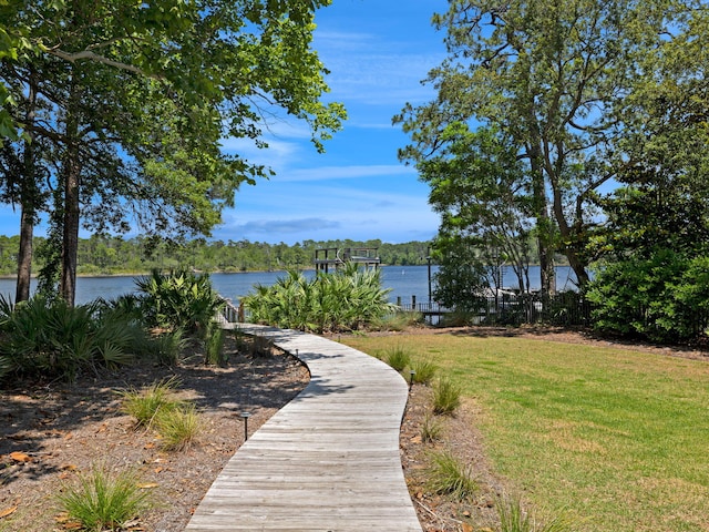 view of home's community featuring a water view and a lawn